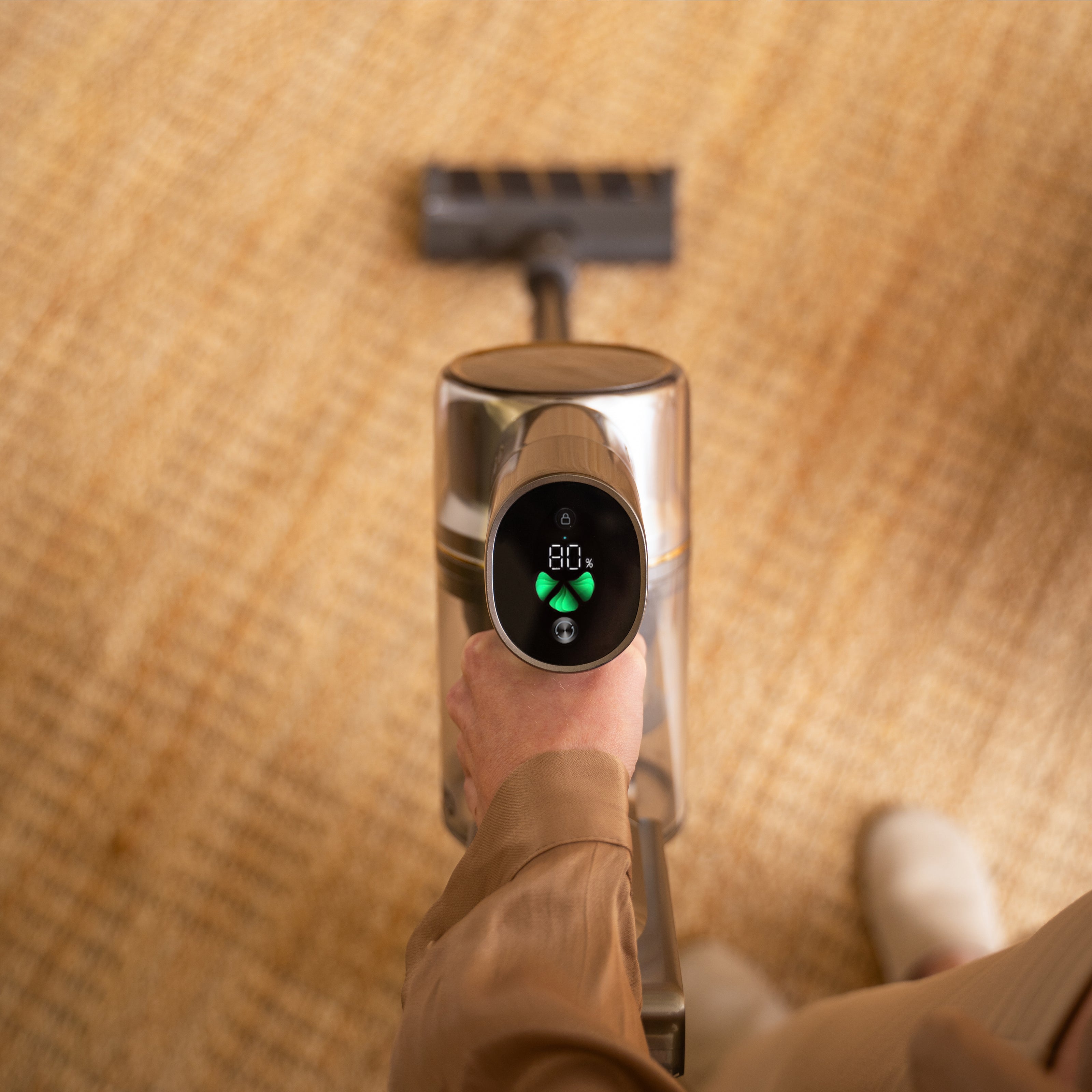 Dreame cordless vacuum with digital display showing 80% battery while cleaning textured carpet flooring